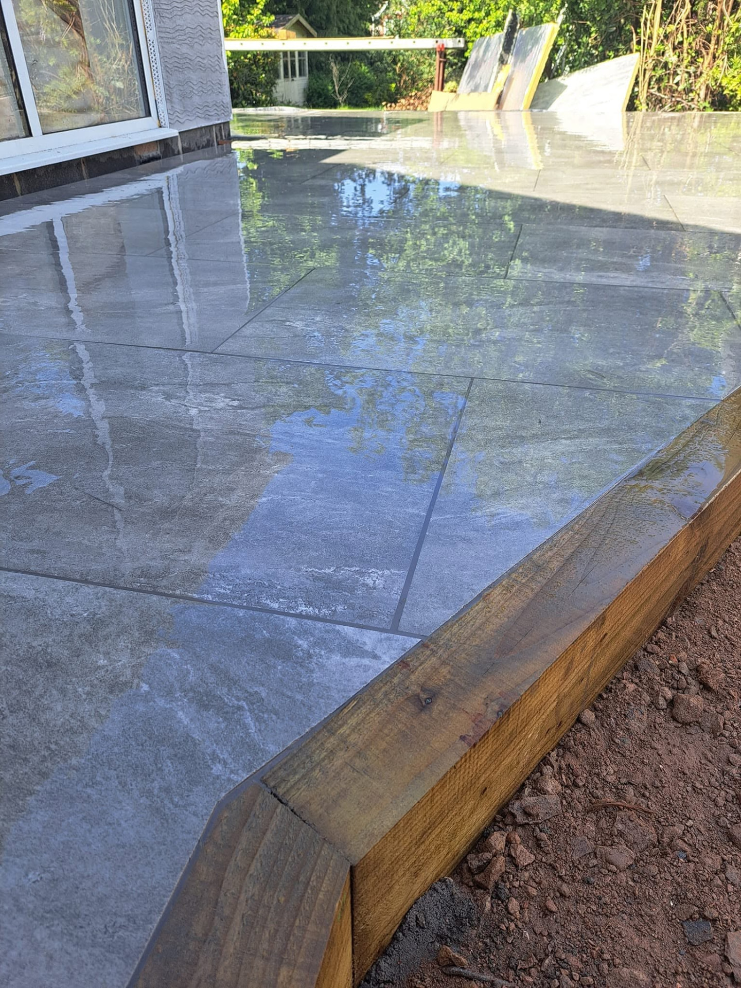 Landscaping: porcelain patio, completed work, supplied project photograph